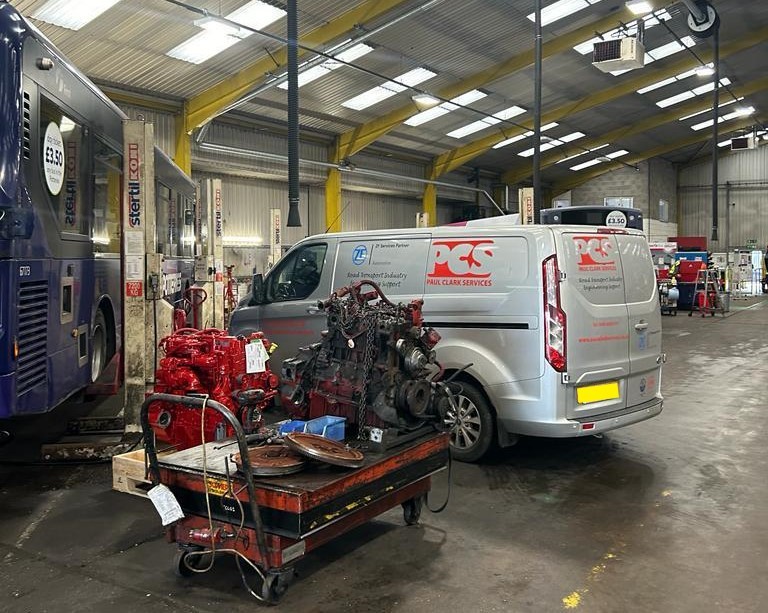 PCS van inside facility with engine removed from a vehicle.