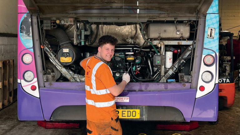 mechanic working on bus engine at Paul Clark Services.