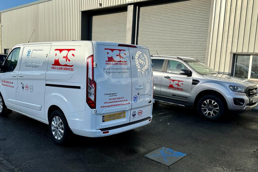 Paul Clark Services livery van next to PCS livery car.