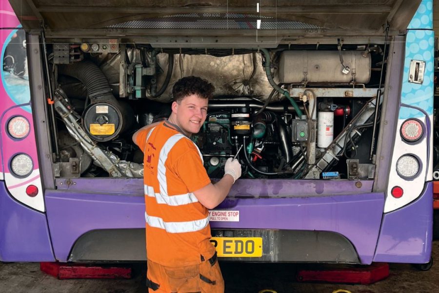 mechanic working on bus engine at Paul Clark Services.