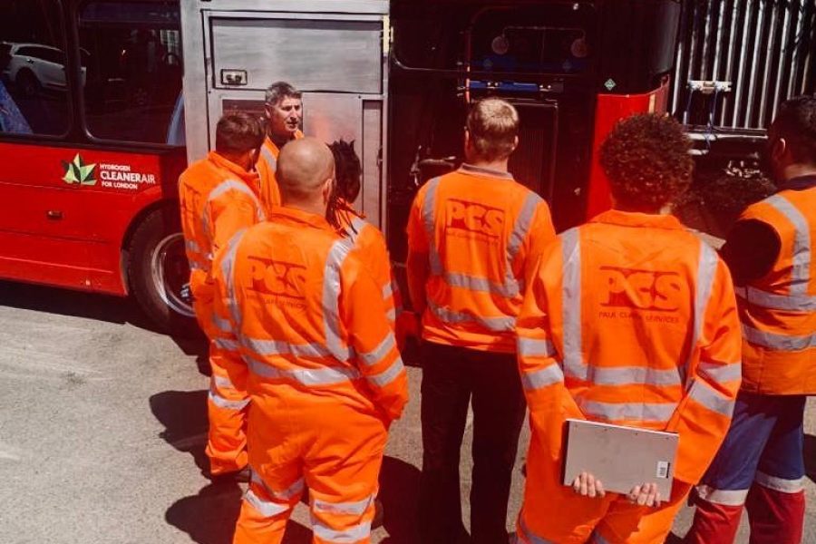 Group of Paul Clark Services Ltd workers listening.